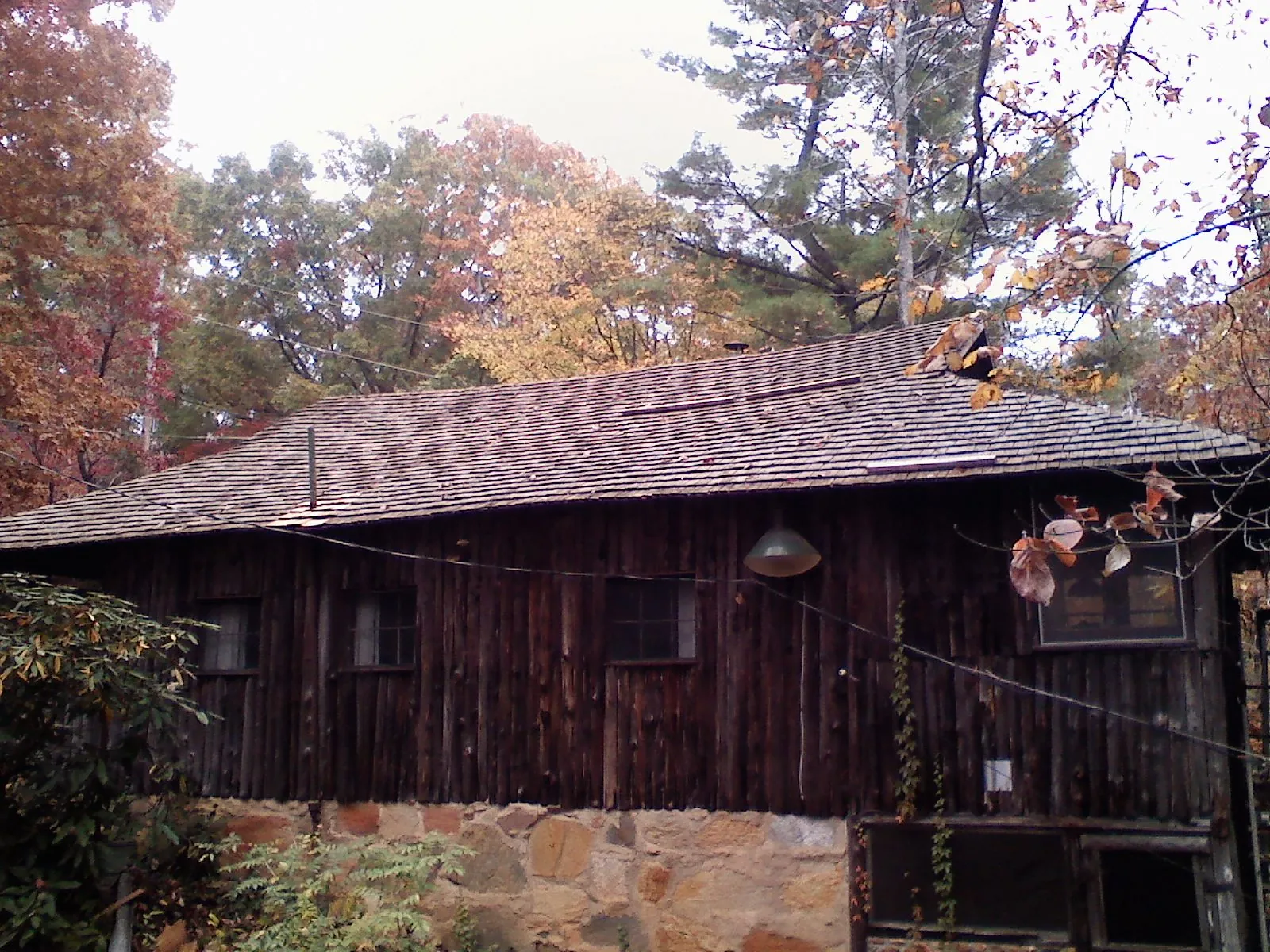 Weathered wood shake roof on a rustic board sided cabin in Etna Green
